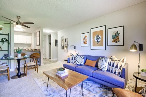 an open living room with a blue couch and a table